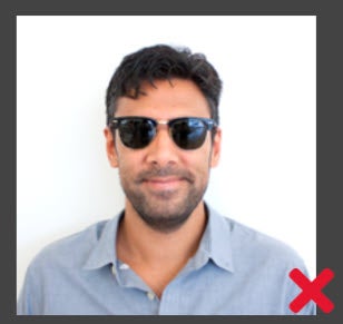 Unacceptable. Take off your sunglasses before taking the photo.