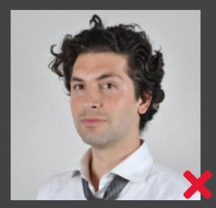 Unacceptable. The customer's head is rotated and the shoulders are not square to the camera.